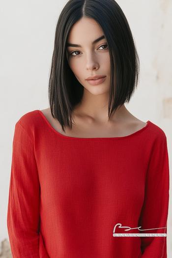 Chic red top showcases eco-friendly fashion in Granada’s sunlight.